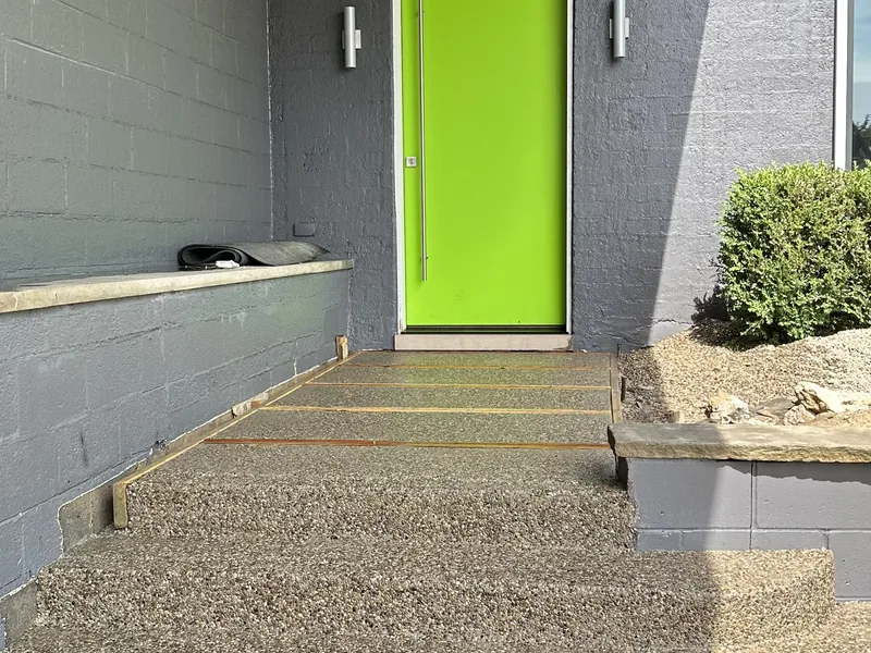 Concrete walk to the door by A&M Works